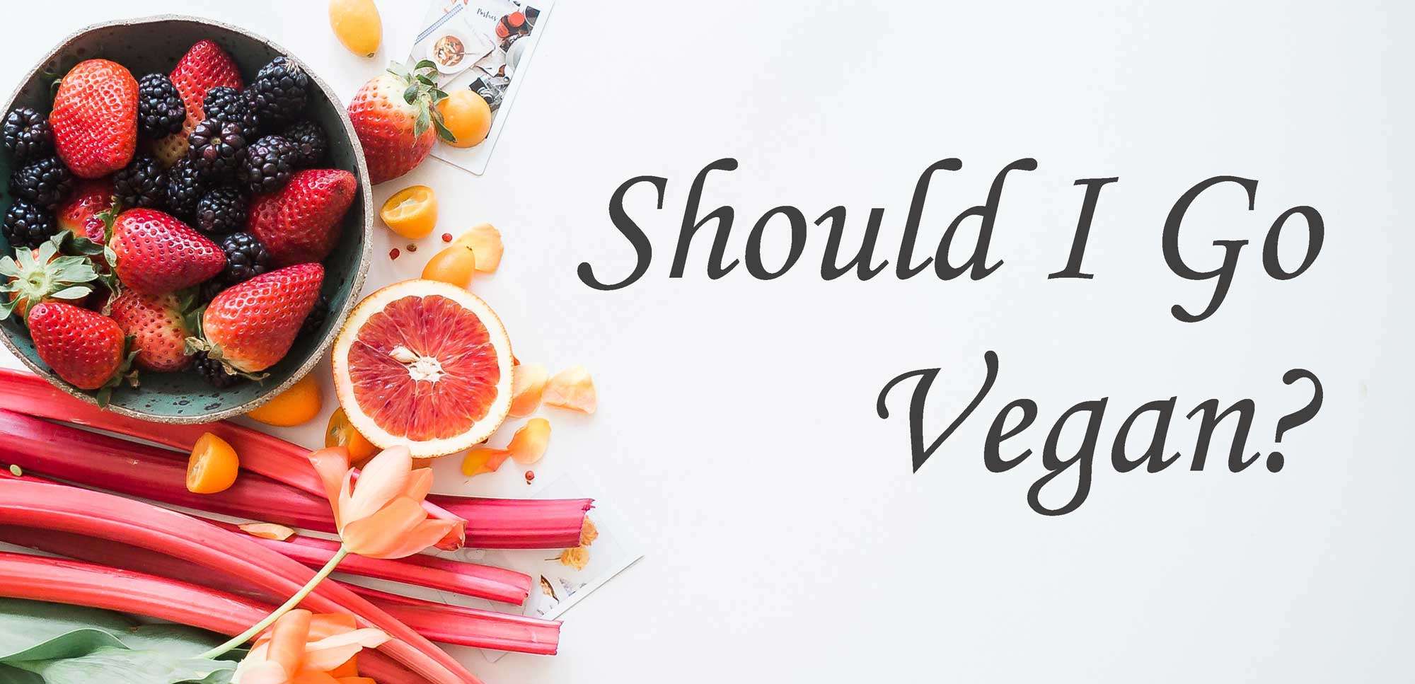 A table topped with fruits and vegetables next to the words " should i eat veggies ?"
